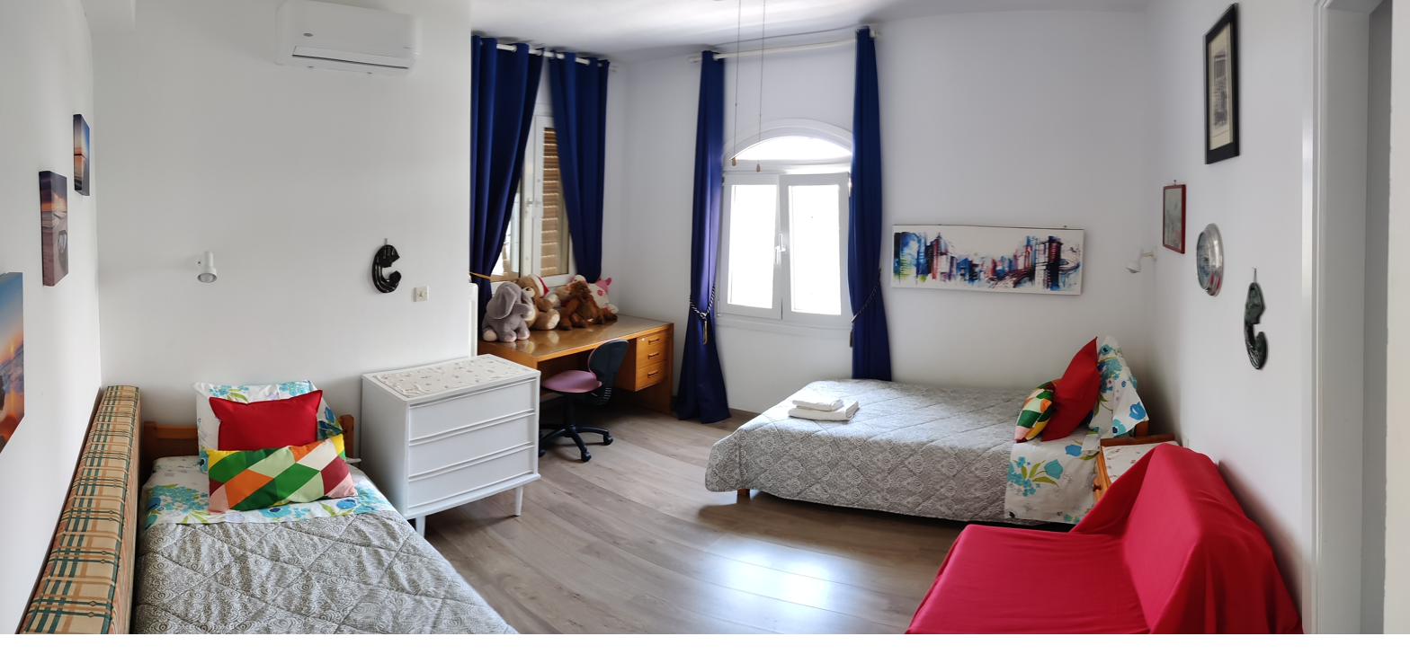 Family bedroom with three beds