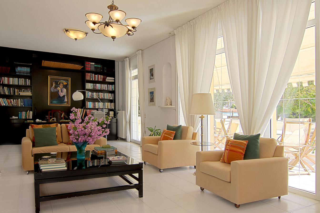 Main living room with library wall and sofas